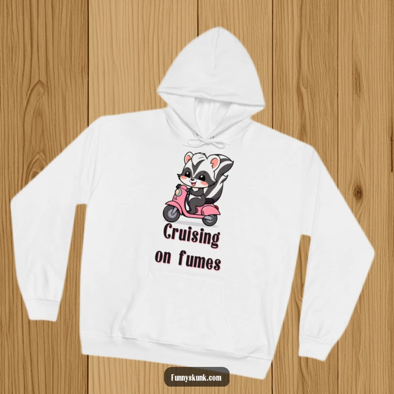 Funny skunk hoodie depicting a cheerful skunk happily riding a tiny scooter, offering warmth and humor.