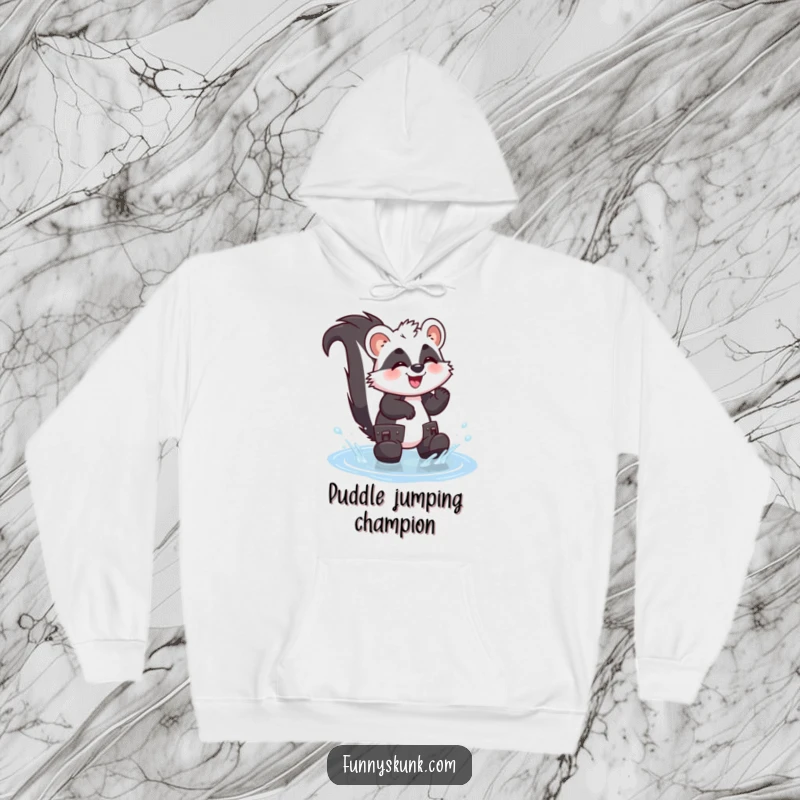 Funny skunk hoodie depicting a giggling skunk wearing oversized boots, splashing with joy in a small puddle, spreading wet humor.
