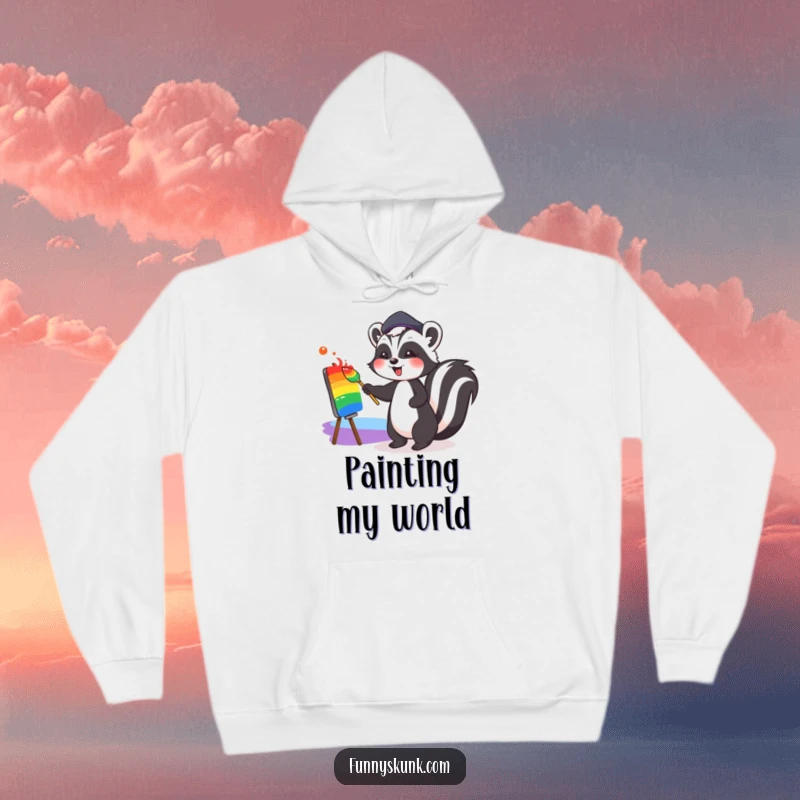 Funny, warm hoodie featuring a cute skunk in a jaunty beret, joyfully painting a vibrant rainbow, perfect for art enthusiasts and comfort.